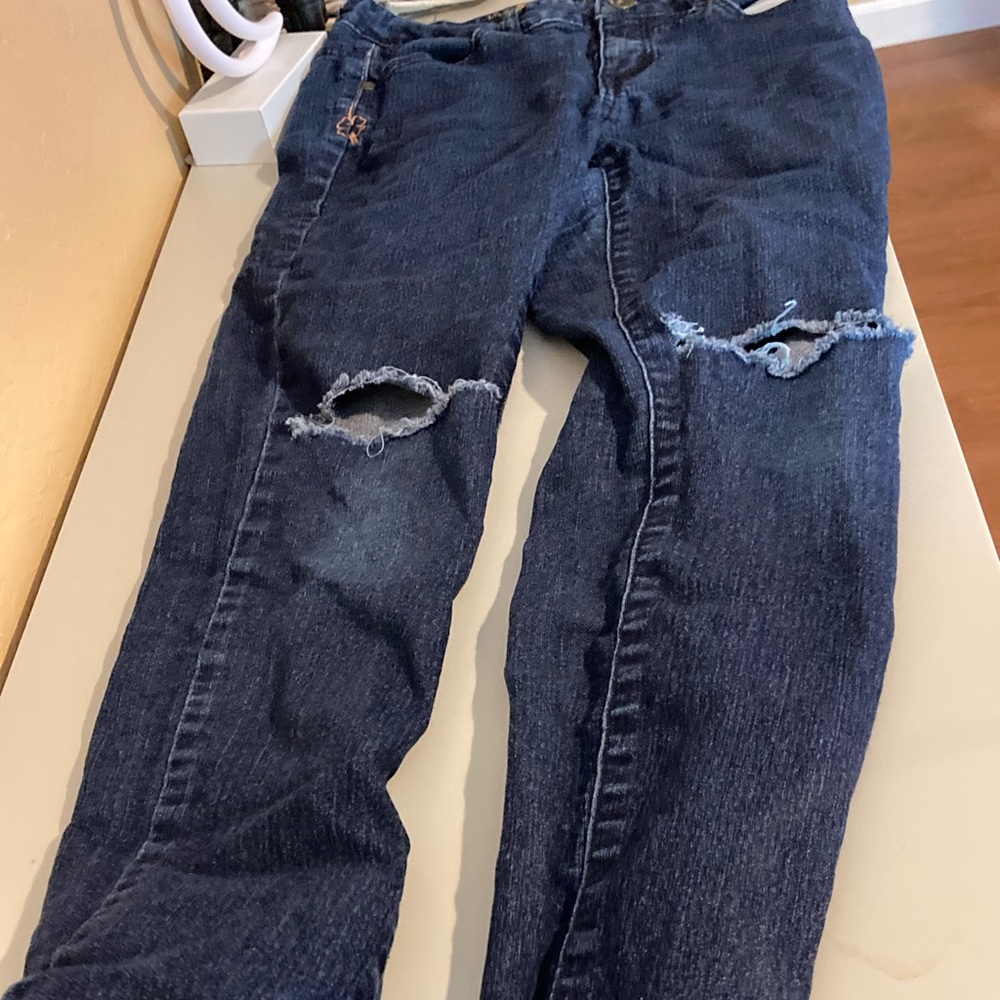 Lucky brand skinny jeans with a tear in each knee